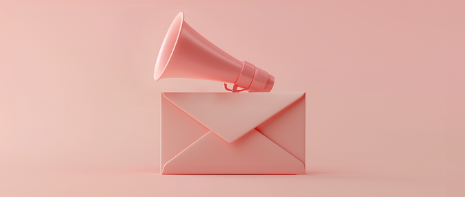 A pink megaphone on top of an envelope, representing email marketing: announcement email