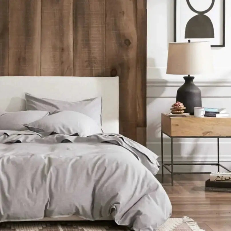 An image of a bedroom styled with plush, neutral bedding and decor.