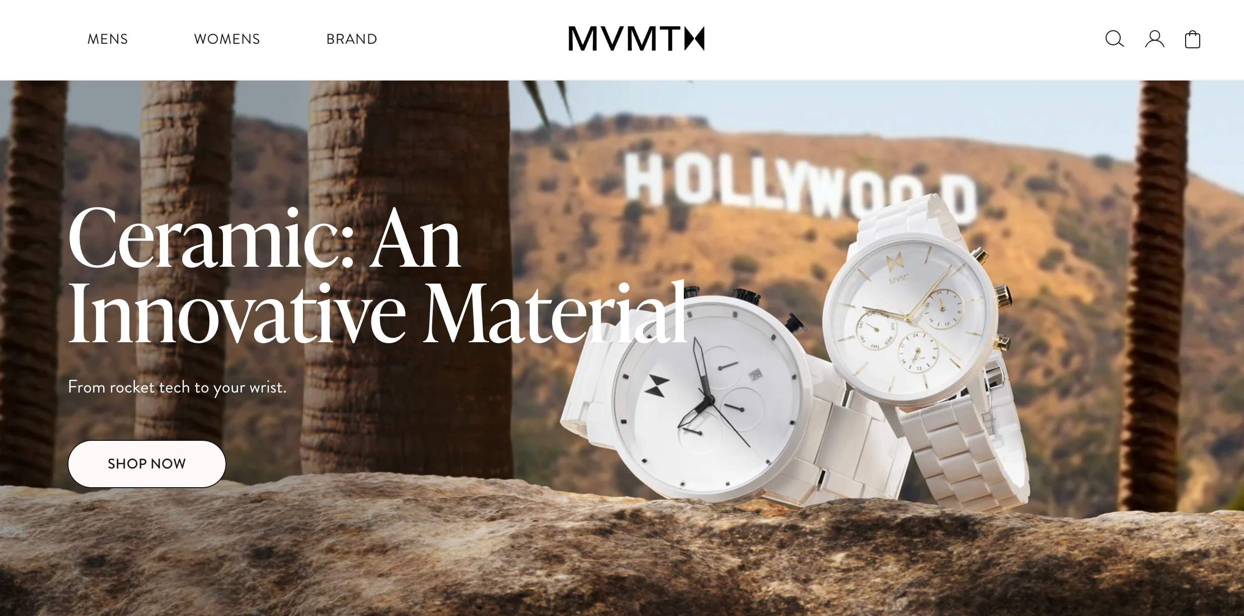 Two white ceramic MVMT watches displayed on a rock with the Hollywood sign in the background.
